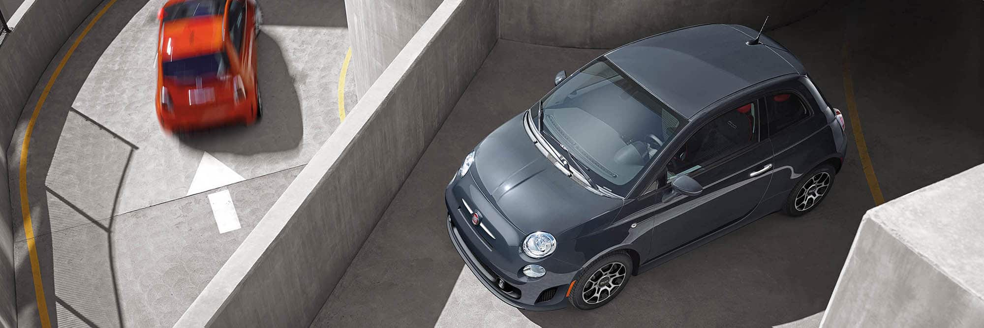 Overhead view of a 2019 Fiat 500 Pop parked on the roof of a parking structure.