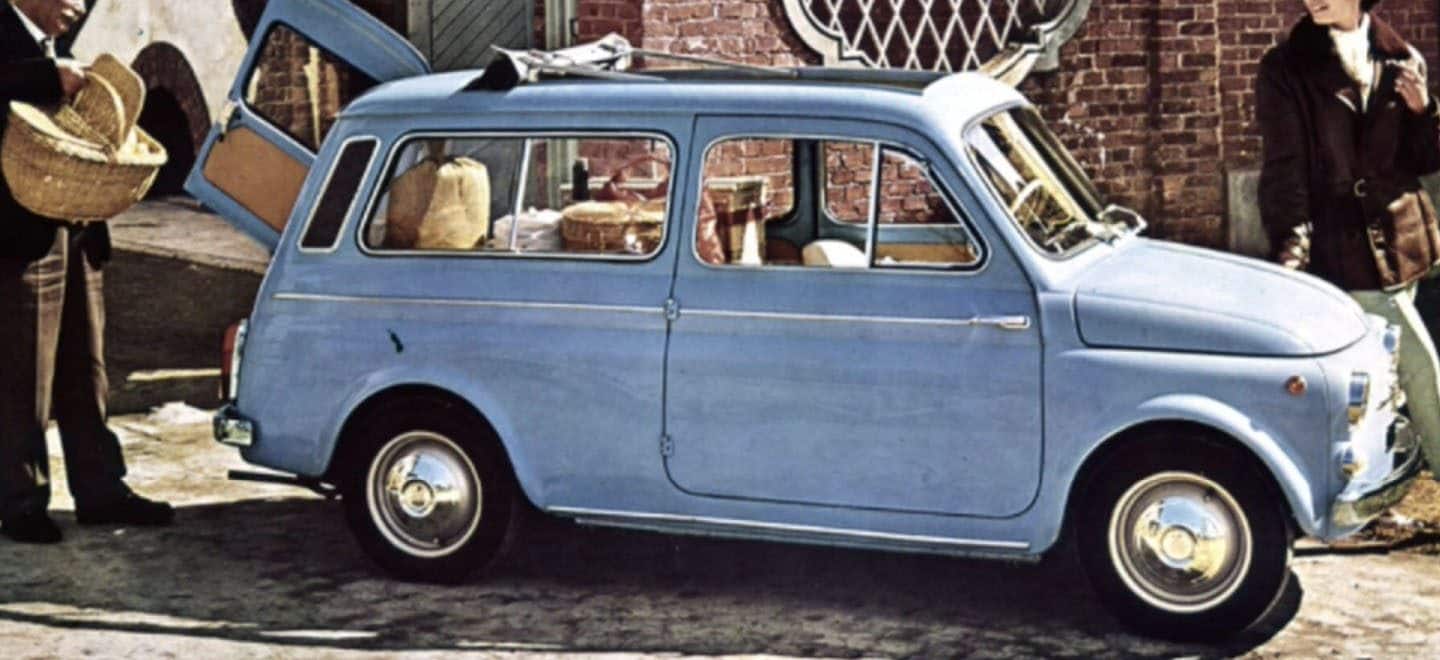 Display A vintage drawing of a classic light blue Fiat wagon with it's side-opening rear hatch open with a man standing by the open door holding a picnic basket and a woman standing by the front.