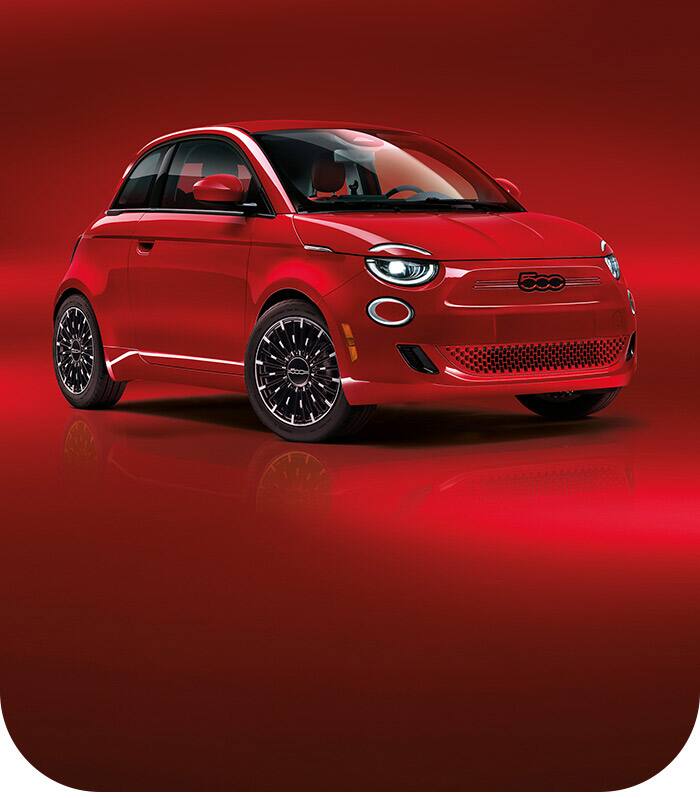 An angled front passenger-side profile of a red 2024 Fiat (Red) 500e Edition.