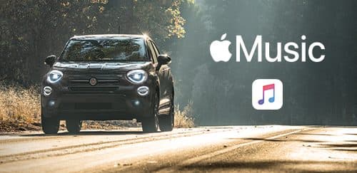 A 2019 Fiat 500X being driven through a wooded area and an enlarged version of the Apple Music logo and Apple Music icon positioned to the right of the vehicle.