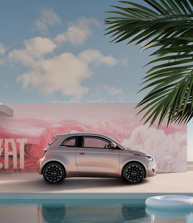 A passenger-side profile of a rose gold 2025 Fiat 500e Icona, behind it a landscape backdrop all in shades of pink.