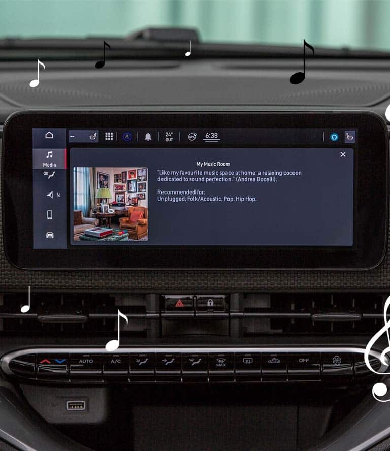 The Uconnect touchscreen in the 2024 Fiat 500e Inspired By Music displaying the JBL Virtual Venue: My Music Room by Andrea Bocelli, with animated black and white musical notes scattered about.