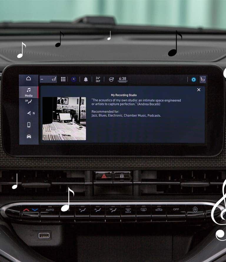 The Uconnect touchscreen in the 2024 Fiat 500e Inspired By Music displaying the JBL Virtual Venue: My Recording Studio by Andrea Bocelli, with animated black and white musical notes scattered about.