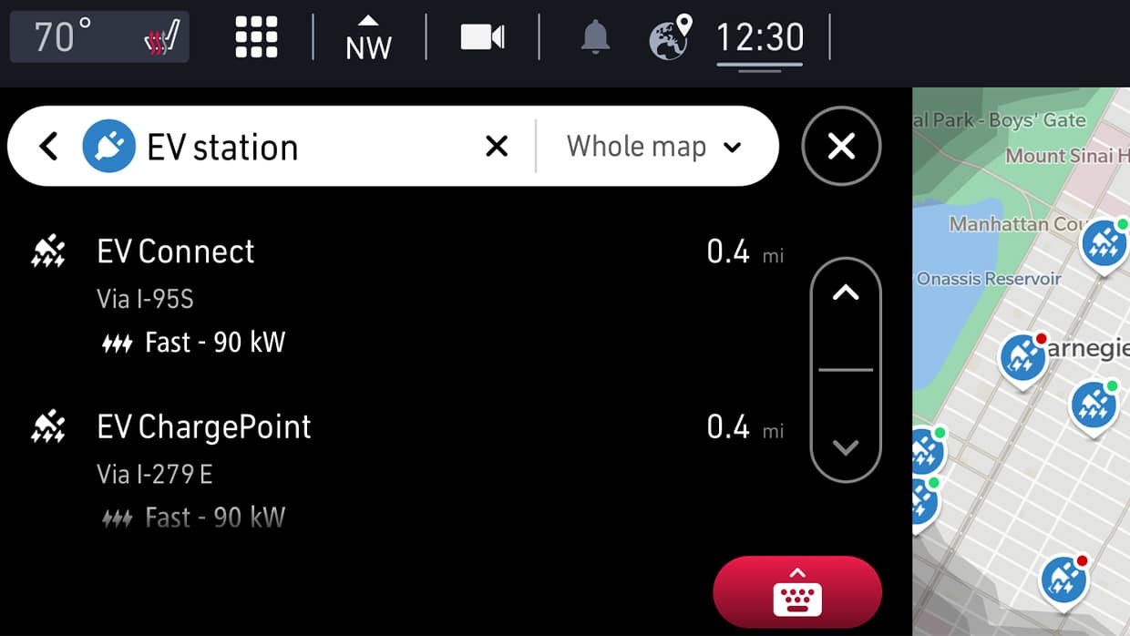 The Uconnect touchscreen on the 2025 Fiat 500e Red, displaying EV charging locations.
