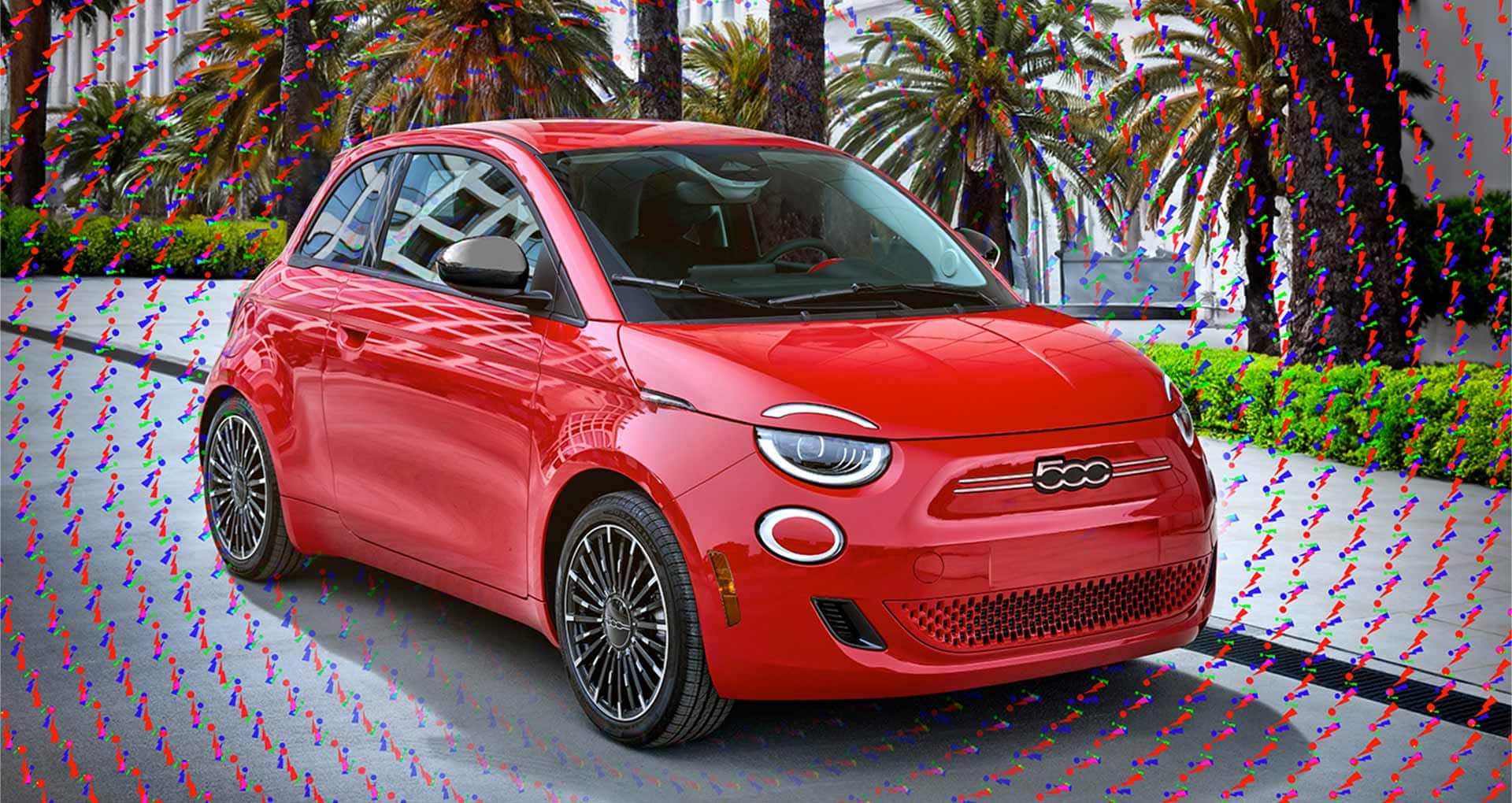 A passenger-side front angle of a 2025 Fiat 500e Red parked on a city street. Hundreds of tiny red, blue and green exclamation points surround the vehicle.