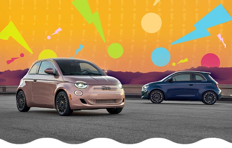 Two Fiat 500e models parked. On the left, a rose gold 2025 Fiat 500e Icona and on the right, a blue 2025 Fiat 500e Icona. The background is filled with several huge, colorful zigzagged exclamation points.