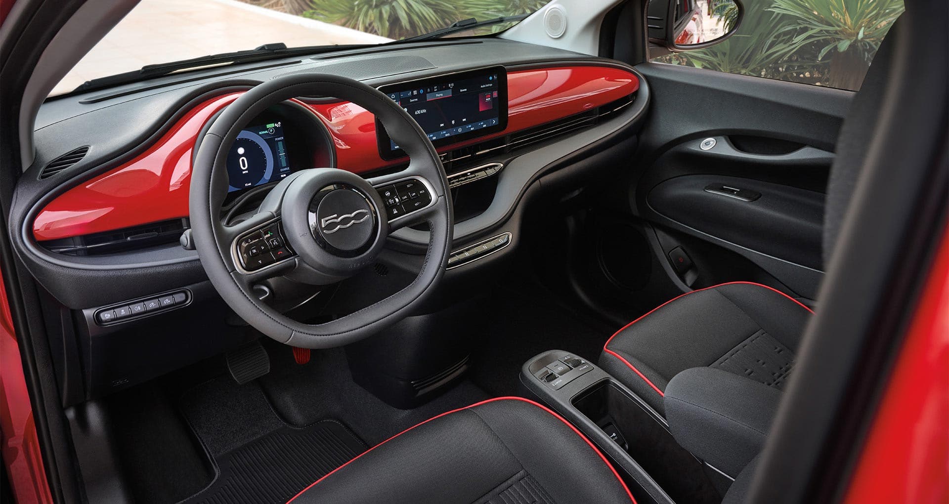 The front row in the 2025 Fiat 500e Red focusing on the seats, steering wheel, Digital Cluster Display and Uconnect touchscreen.