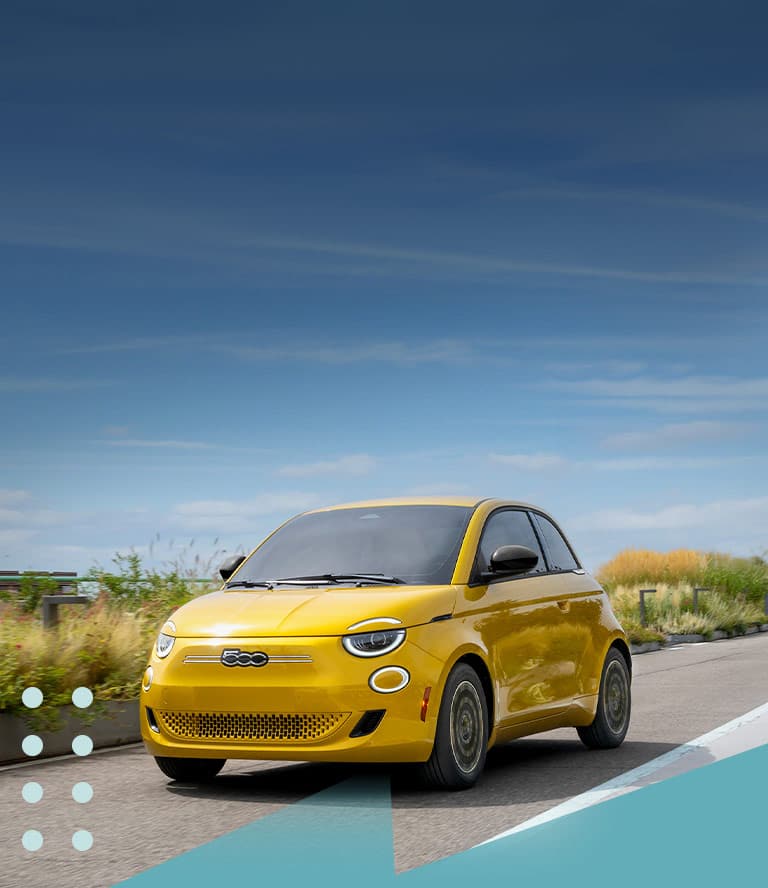 A yellow 2026 Fiat 500e Pop traveling down a highway.