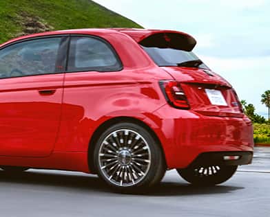 A red 2026 Fiat 500e Pop focusing on the driver-side rear of the vehicle.