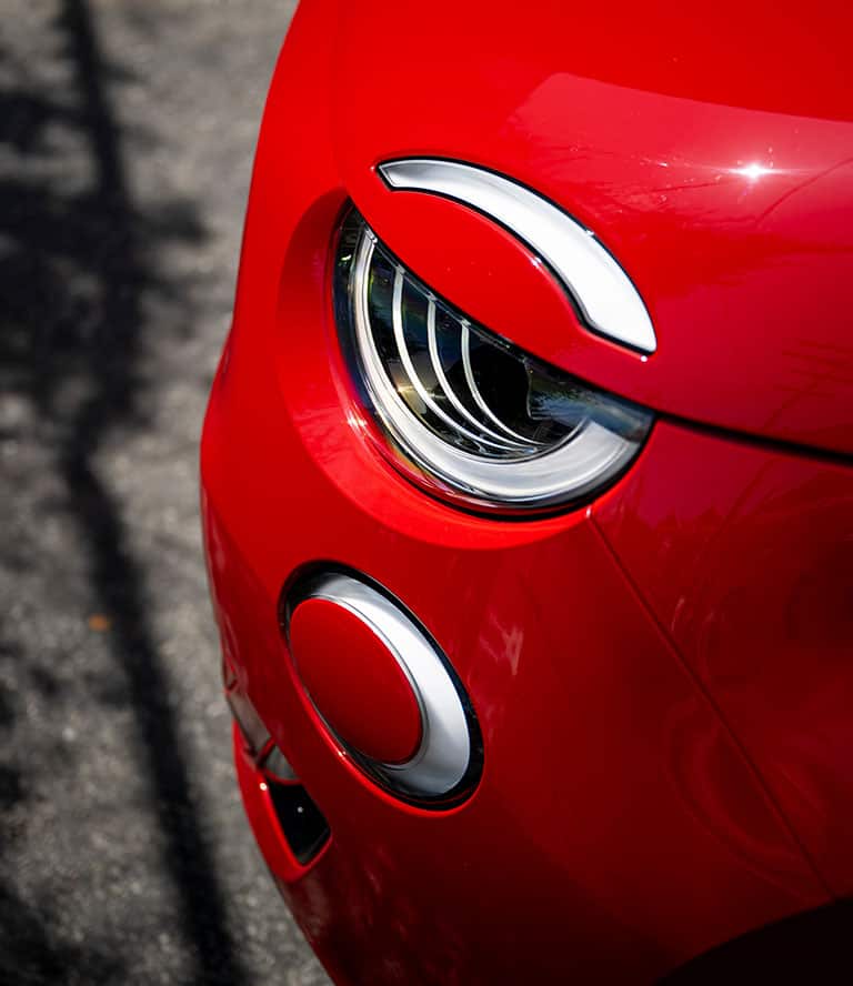 A close-up of a headlamp on a 2024 Fiat 500e.