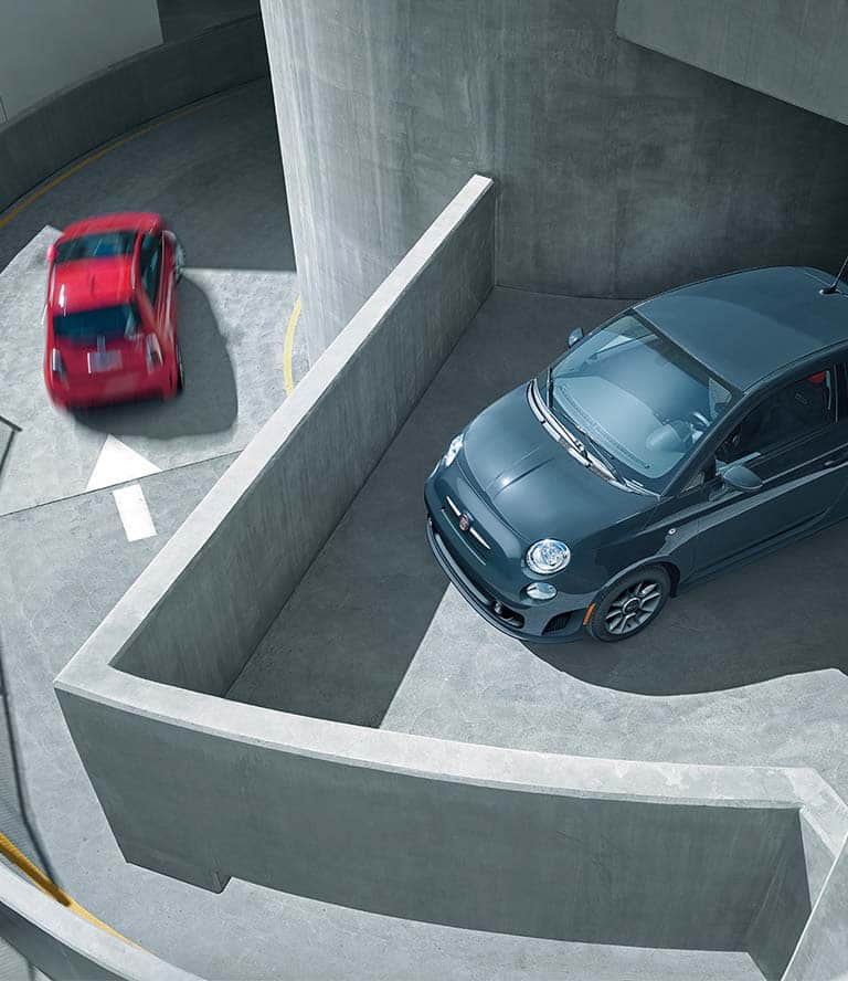 Overhead view of a 2019 Fiat 500 Pop parked on the roof of a parking structure.