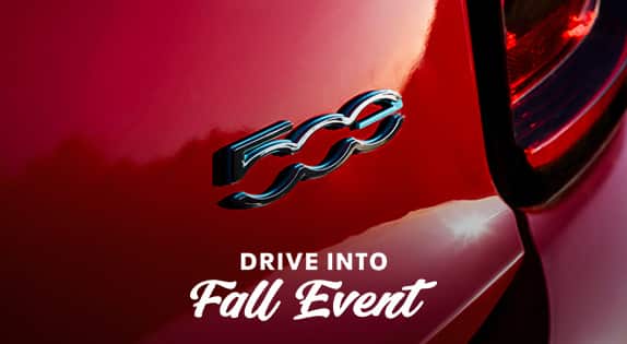 A close-up angle of a 2024 Fiat 500e logo.