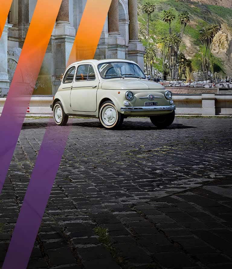 A red Fiat 500 sits parked next to a vintage Fiat vehicle in a cobblestone courtyard with neon-colored diagonal lines superimposed over it.