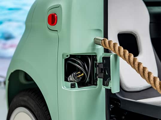 A close-up shot of the charging port on a Fiat Topolino Dolce Vita.