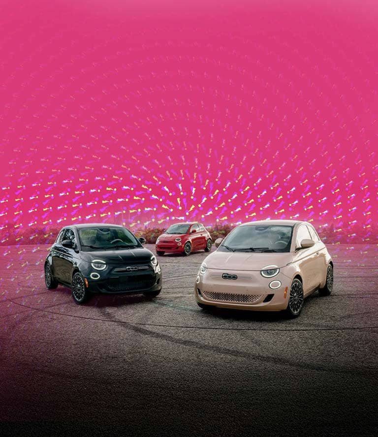 Three Fiat 500e models parked in a semicircle. From left to right: A black 2025 Fiat 500e Icona, a red 2024 Fiat 500e Inspired and a rose gold 2025 Fiat 500e Icona.