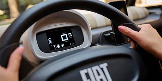 The steering wheel and instrument cluster in the European model Fiat Topolino.