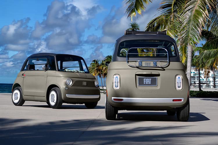 Two Luna Greige 2027 Fiat Topolino Open Air vehicles parked in a beachside lot with palm trees in the background.